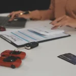 Buyer getting the keys to a cheap used car after signing the paperwork